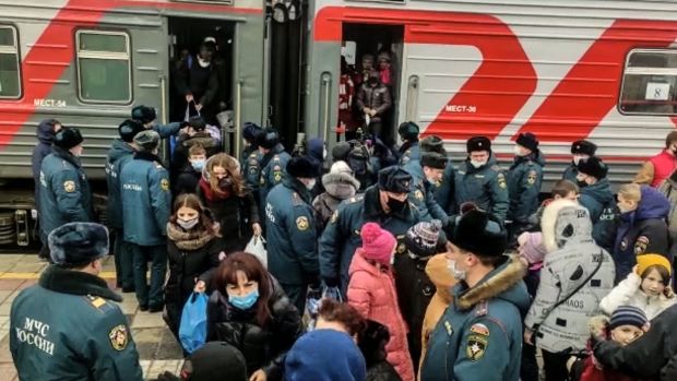 A handout by the Russian emergency situations ministry shows people evacuated from the self-proclaimed Donetsk People’s Republic arriving to the railway station in the city of Voronezh. Photograph: Handout/Russian emergency situations min/AFP via Getty Images