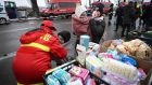 A Romanian employee of the emergency services helps a Ukrainian family  at the Ukrainian-Romanian border in Siret.   Photograph: Daniel Mihailescu/AFP/Getty Images