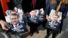 French centrist La Republique En Marche (LREM) party volunteers hand out campaign flyers of French President  Emmanuel Macron on a street market in Paris. Photograph: Ludovic Marin/AFP via Getty Images)