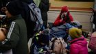 Refugees fleeing the Russian invasion of Ukraine wait at a train station in Przemysl, Poland: Up to 100,000 Ukrainians are expected to arrive in Ireland in the coming  weeks. Photograph: Erin Schaff/New York Times