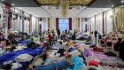Refugees who fled the Russian invasion from neighbouring Ukraine sit inside a ballroom converted into a makeshift refugee shelter at a 4-star hotel and spa, in Suceava, Romania, Friday, March 4th, 2022. Photograph: AP Photo/Andreea Alexandru