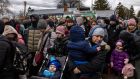 Refugees fleeing Ukraine following the Russia invasion wait to cross the border into Medyka, Poland on Tuesday. Photograph: Ivor Prickett/The New York Times