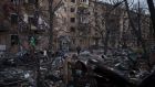 Police officer walks at the site of a bombing that damaged residential buildings in Kyiv, Ukraine. Photograph: Felipe Dana/AP Photo