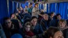 Ukrainian refugees  on a bus after it crossed  the Ukrainian border into Poland at the Medyka border crossing.  Photograph: Angelos Tzortzinis/AFP