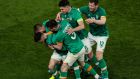 Troy Parrott is mobbed by his Ireland team-mates after scoring the late winner against Lithuania at the Aviva Stadium. Photograph: Evan Treacy/Inpho