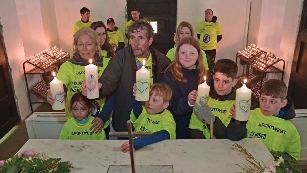 Claire Mold and Charlie Bird with his grandkids after they lit five candles in the church on the summit of Croagh Patrick.  Photograph: Conor McKeown