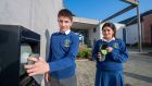 Pobalscoil Chorca Dhuibhne students Sean Ó Cuinn and Faye Greely arrive at school, where their phones are kept in a secure magnetic pouch for the duration of the school day. Photograph: Domnick Walsh 