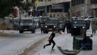A Palestinian throws stones at Israeli troops during clashes in the West Bank city of Nablus on Wednesday. Photograph:  Alaa Badarneh/EPA 