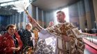 BLESSING: Fr Vasyl Kornitsky blesses the congregation and traditional Ukrainian Easter foods at a Mass in Our Lady of Consolation Church, Donnycarney, Dublin. Photograph: Tom Honan