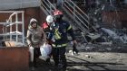 Rescuers help a resident to  leave a damaged building in Odesa, on Sunday.  A Russian strike on a residential building in the city the day before  killed eight people, including a baby. Photograph:  Oleksandr GImanov/AFP via Getty Images