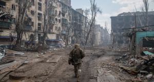 A Russian soldier walks amid the rubble of Mariupol in Ukraine. Photograph: Maximilian Clarke/SOPA Images/LightRocket via Getty Images