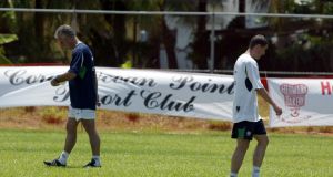 Mick McCarthy and Roy Keane pass each other during training in Saipan on May 21st, 2002. Photograph: Andrew Paton/Inpho