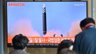  People watch a television screen showing a news broadcast a North Korean missile test. Photograph: Jung Yeon-je/AFP/Getty Images