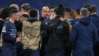 Manchester City’s Catalan manager Pep Guardiola speaks to his players after their defeat at the Bernabeu. Photograph: Getty Images