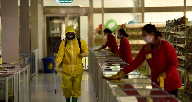 Employees spray disinfectant and wipe surfaces as part of preventative measures against  Covid-19  at a children’s department store in Pyongyang on March 18th. Photograph:  Kim Won-jin/AFP via Getty Images
