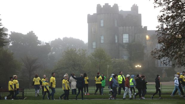 People walk past Malahide Castle in County Dublin as part of the Darkness Into Light march this morning.  Photography: Dara MacDonail/The Irish Times