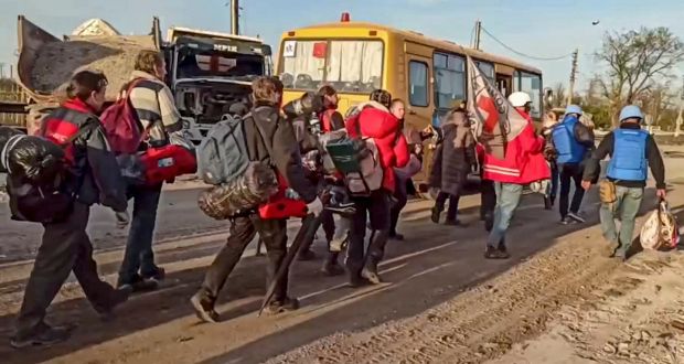 Russian servicemen and Red Cross volunteers escorting civilians who were evacuated from Azovstal, in Mariupol, to buses. Photograph: EPA/Russian Defence Ministry