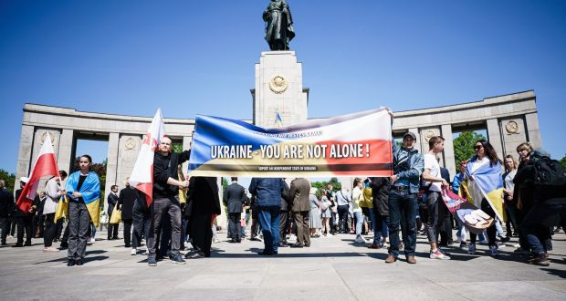  Activists with a banner reading ’Ukraine - You Are Not Alone’ in front of the Soviet War Memorial in Berlin, Germany. Photograph: Clemens Bilan/EPA
