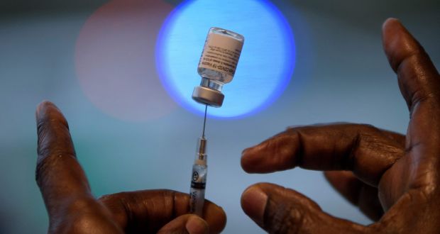 A healthcare worker prepares a dose of the Pfizer/BioNTech Covid-19 vaccine. Photograph: Mark Felix/AFP via Getty Images