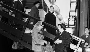 Beatrice Blyth, right, of the Liverpool Vigilance Association, a group of housewives organised to fight vice, greets new arrivals from Ireland in May 1958.  Ann Hughes (18), Noreen Byrne (18) Rose Maguire (19) and Irene Mullen (19) all from Dundalk, Co Louth,  were bound for London to train as nurses. Photograph:  Charlie Owens/Mirrorpix/Getty Images