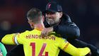 Jürgen Klopp, manager of Liverpool, celebrates their side’s victory with Jordan Henderson. Photograph: Clive Rose/Getty