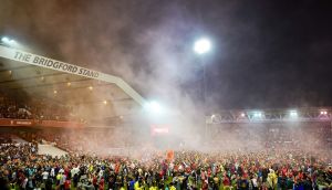 Nottingham Forest fans celebrate on the pitch after they reach the playoff final  at the City Ground, Nottingham. Photograph: Zac Goodwin/PA Wire