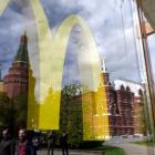 The Kremlin’s towers and passersby are seen reflected in the window of a closed McDonald’s restaurant in Moscow. Photograph: Natalia Kolesnikova/AFP