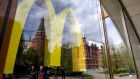 The Kremlin’s towers and passersby are seen reflected in the window of a closed McDonald’s restaurant in Moscow. Photograph: Natalia Kolesnikova/AFP