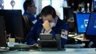Traders on the floor of the New York Stock Exchange: The Dow Jones Industrial Average fell more than 1,000 points as markets continue their volatile trend. Photograph: Spencer Platt/Getty 
