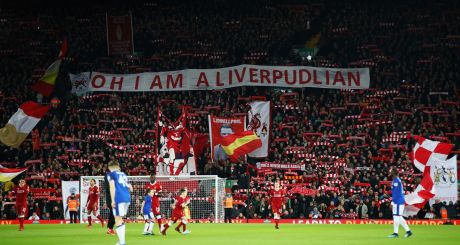 Liverpool fans wave flags and banners at the Kop end at Anfield. Photograph: Clive Brunskill/Getty Images