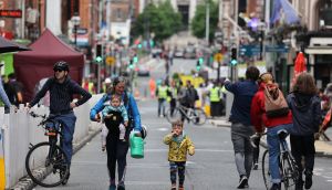   Louise O’Connor (centre), with her childen Bredndan (3) and Maeve (1) on a traffic-free Capel Street on Friday. Photograph: Nick Bradshaw/The Irish Times