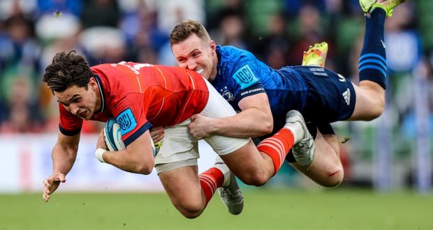 Munster’s Joey Carbery is tackled by Rory O’Loughlin of Leinster  during the United Rugby Championship match at the  Aviva Stadium. Photograph: Ben Brady/Inpho