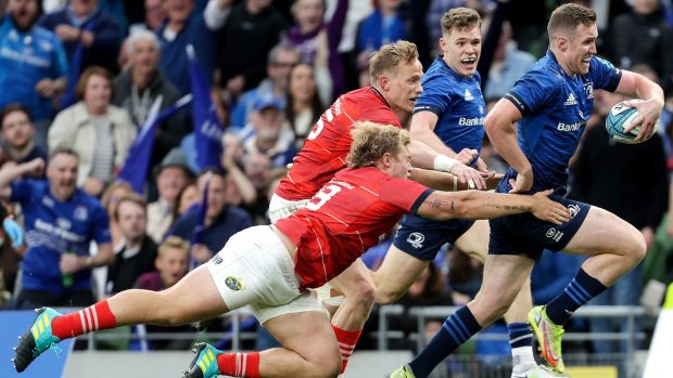 Leinster’s Rory O’Loughlin on his way to scoring a try despite Keynan Knox and Mike Haley of Munster during the United Rugby Championship match at the Aviva Stadium. Photograph: Laszlo Geczo/Inpho
