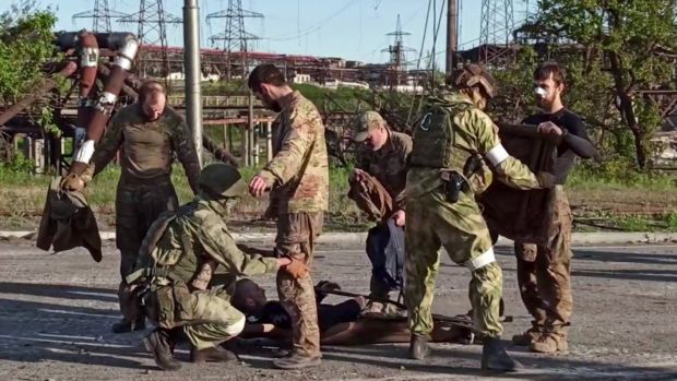 Ukrainian service members are searched by pro-Russian military personnel after leaving the besieged Azovstal steel plant in Ukraine’s port city of Mariupol. Photograph: Russian defence ministry/AFP via Getty Images