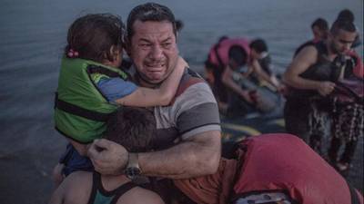 Man photographed crying with family on Kos reaches Berlin