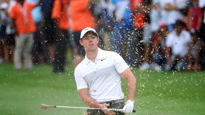 Rory McIlroy battles through  pain to remain in hunt
