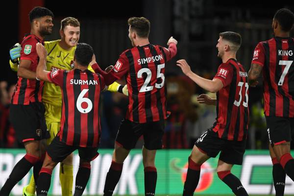 Mark Travers’ hat-trick of penalty saves puts Bournemouth through