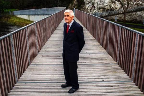 Businessman building bridge to a more equal Ireland