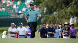 Man with the green glove leads race for green jacket