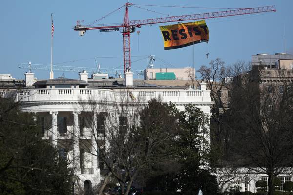 Resist: protesters unfurl banner on crane near White House