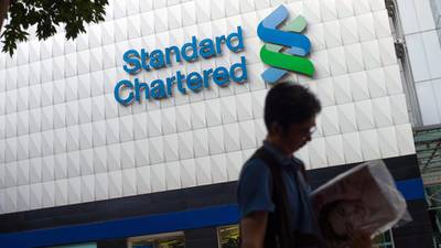 Standard Chartered halves dividend as profits fall 44%