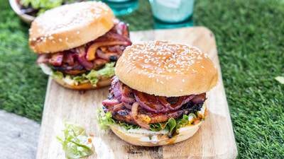 Gochujang glazed grilled chicken burger with tarragon aioli and sweet pickled red onions