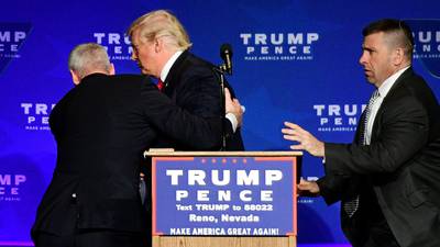 Security hustles Trump from stage after protester displays sign