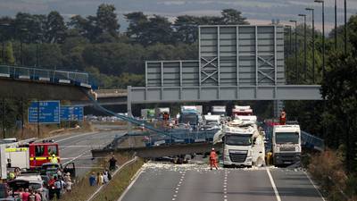 Bridge  collapses onto motorway after being hit by lorry