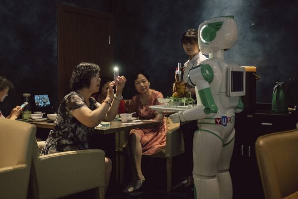 So mad about tech, China even loves its robot waiters that can’t serve