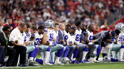 Dallas Cowboys booed for briefly taking a knee before anthem