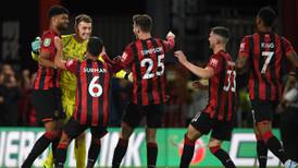 Mark Travers’ hat-trick of penalty saves puts Bournemouth through