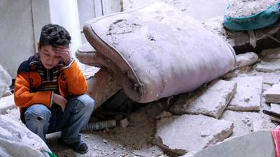 Syrian forces drop barrel bombs on rebel town, killing  at least 50
