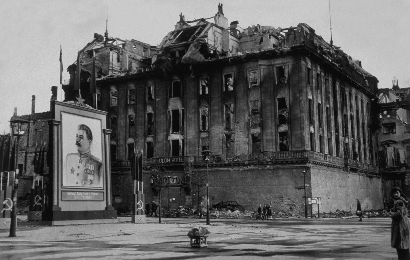 The damaged Adlon Hotel on the Unter Den Linden in Berlin, next to a vast picture of Stalin erected by the Russians in 1945. Photograph: Getty