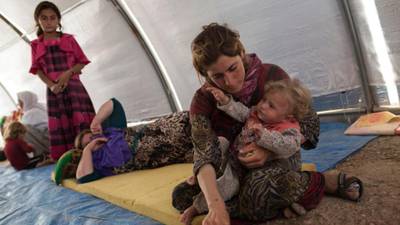 Scrambling down an Iraqi mountain, Yazidi families search for their missing